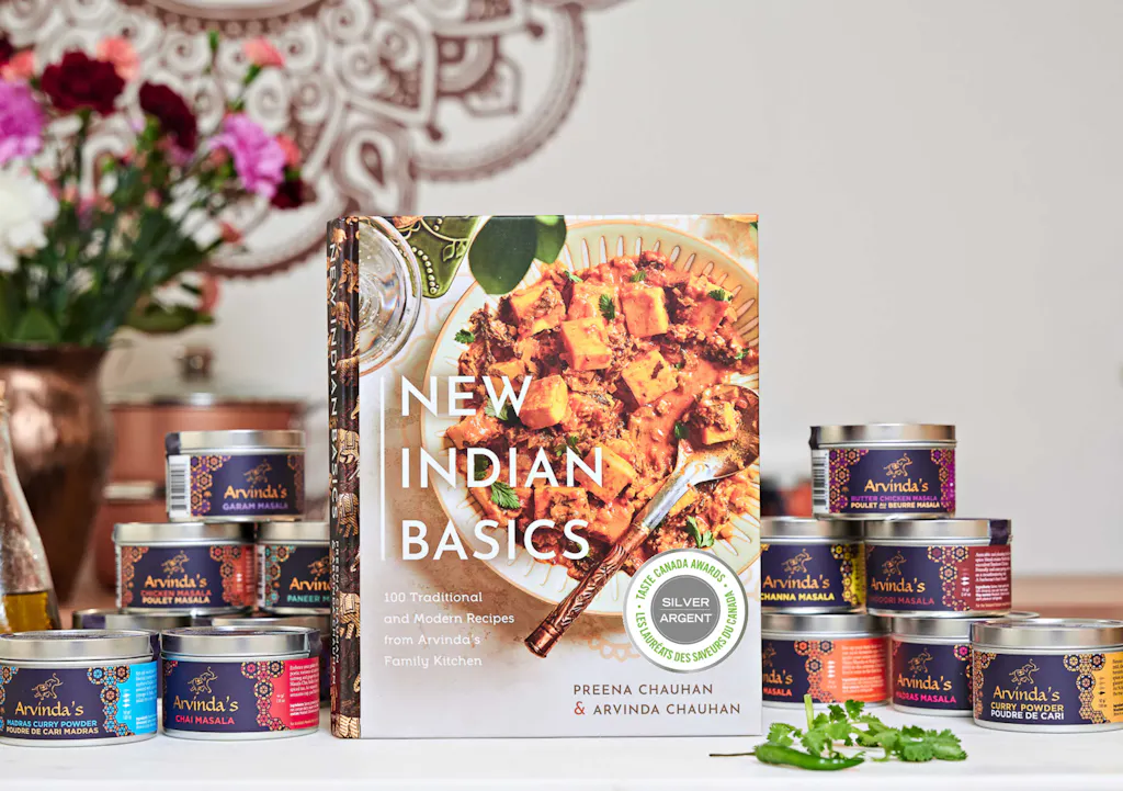 New Indian Basics with Arvinda's masala spice tins on a kitchen counter