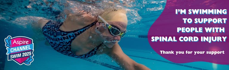 Women in hat and goggles swimming with head under water