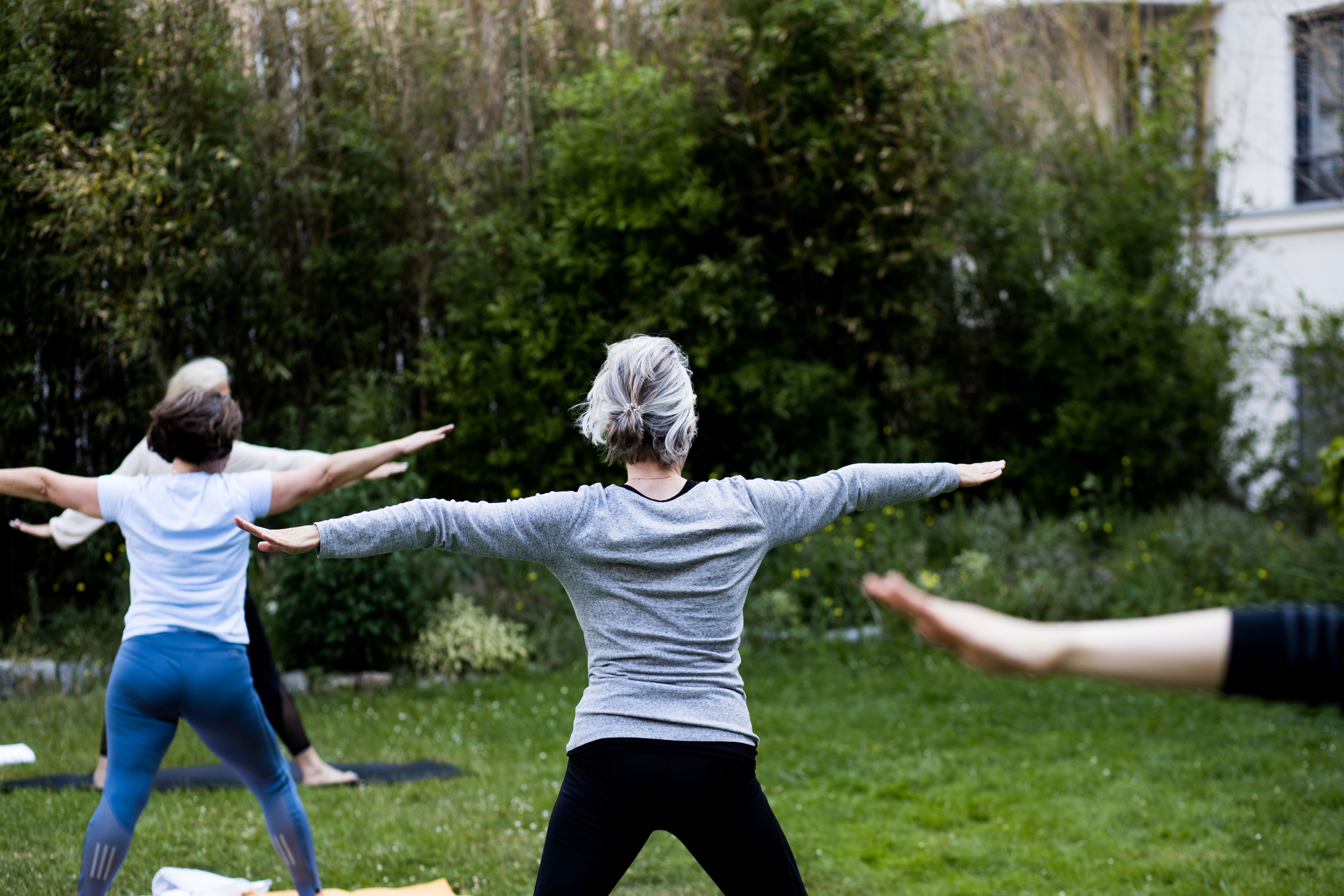 Lady holding pose in an outdoor yoga class