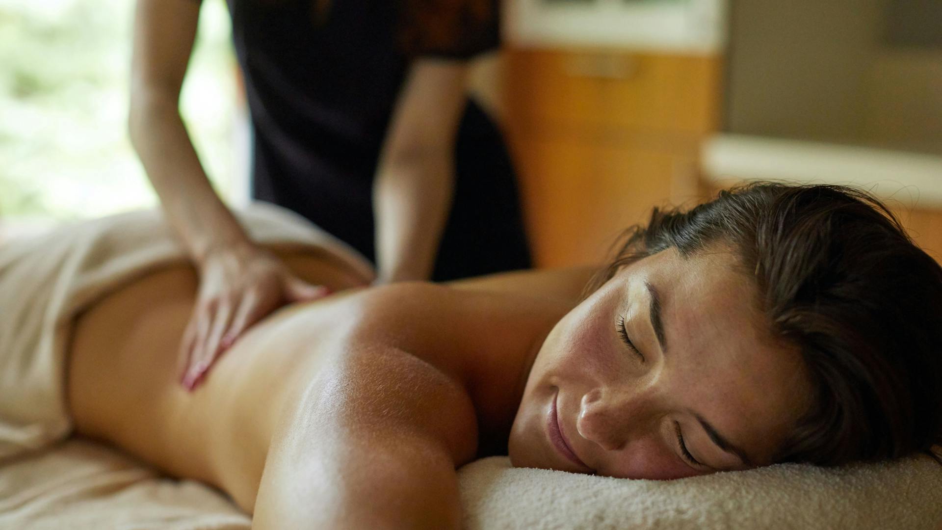 Female getting a back massage from a trained therapists