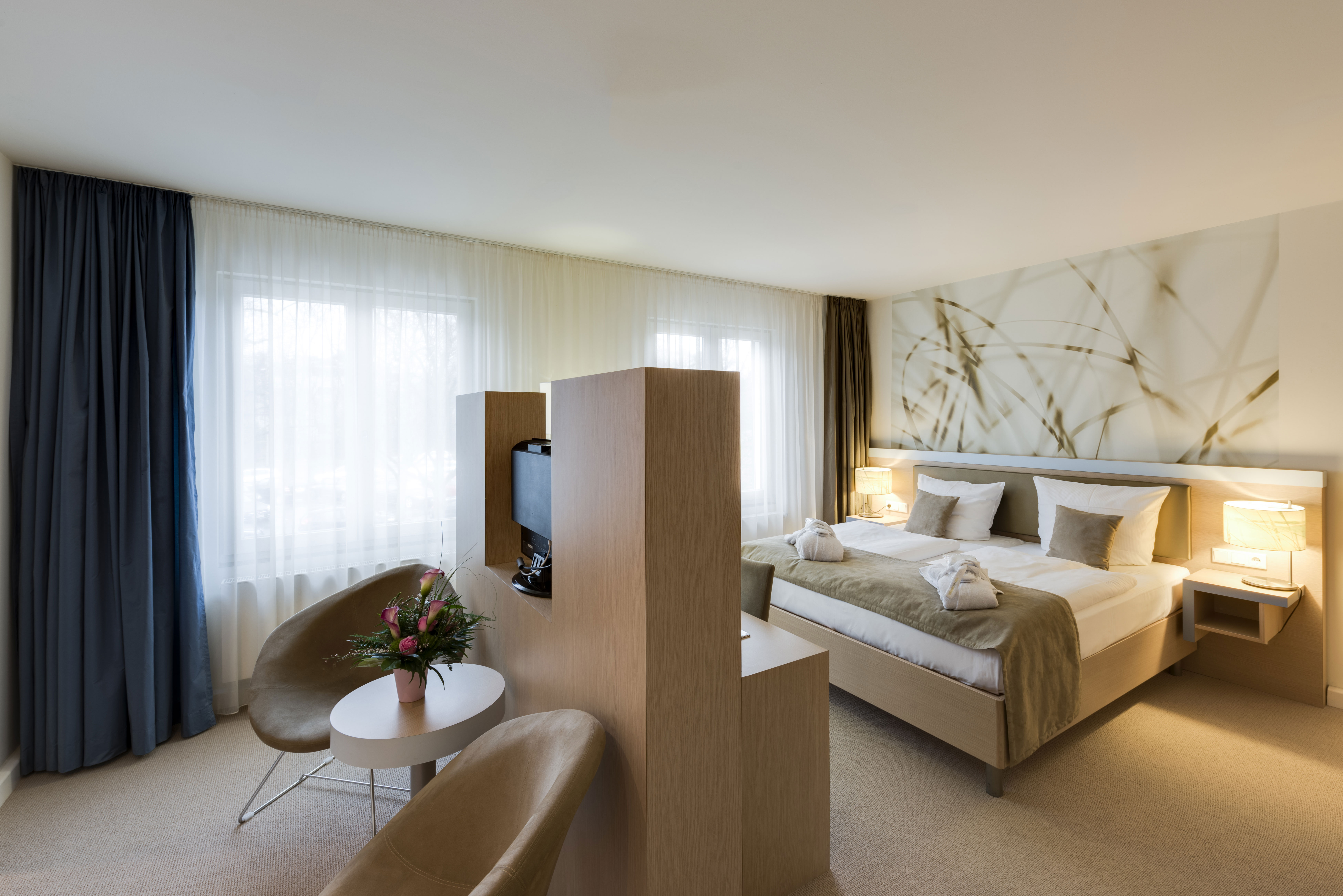 Hotel room with chairs and bed 