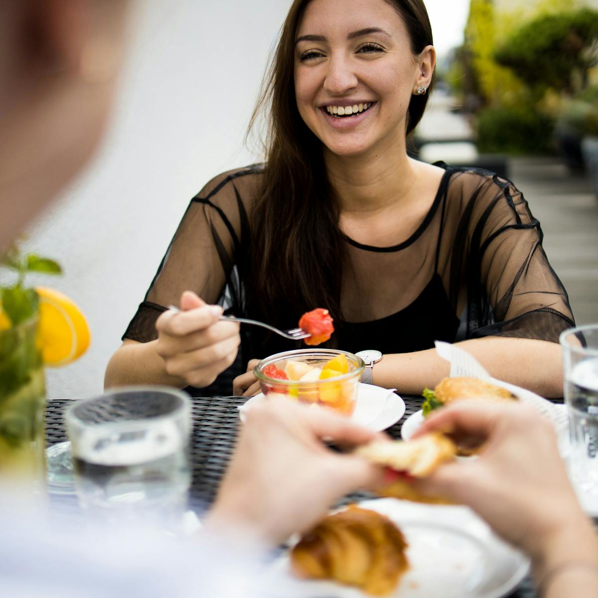 Women eating fresh fruit with her friend