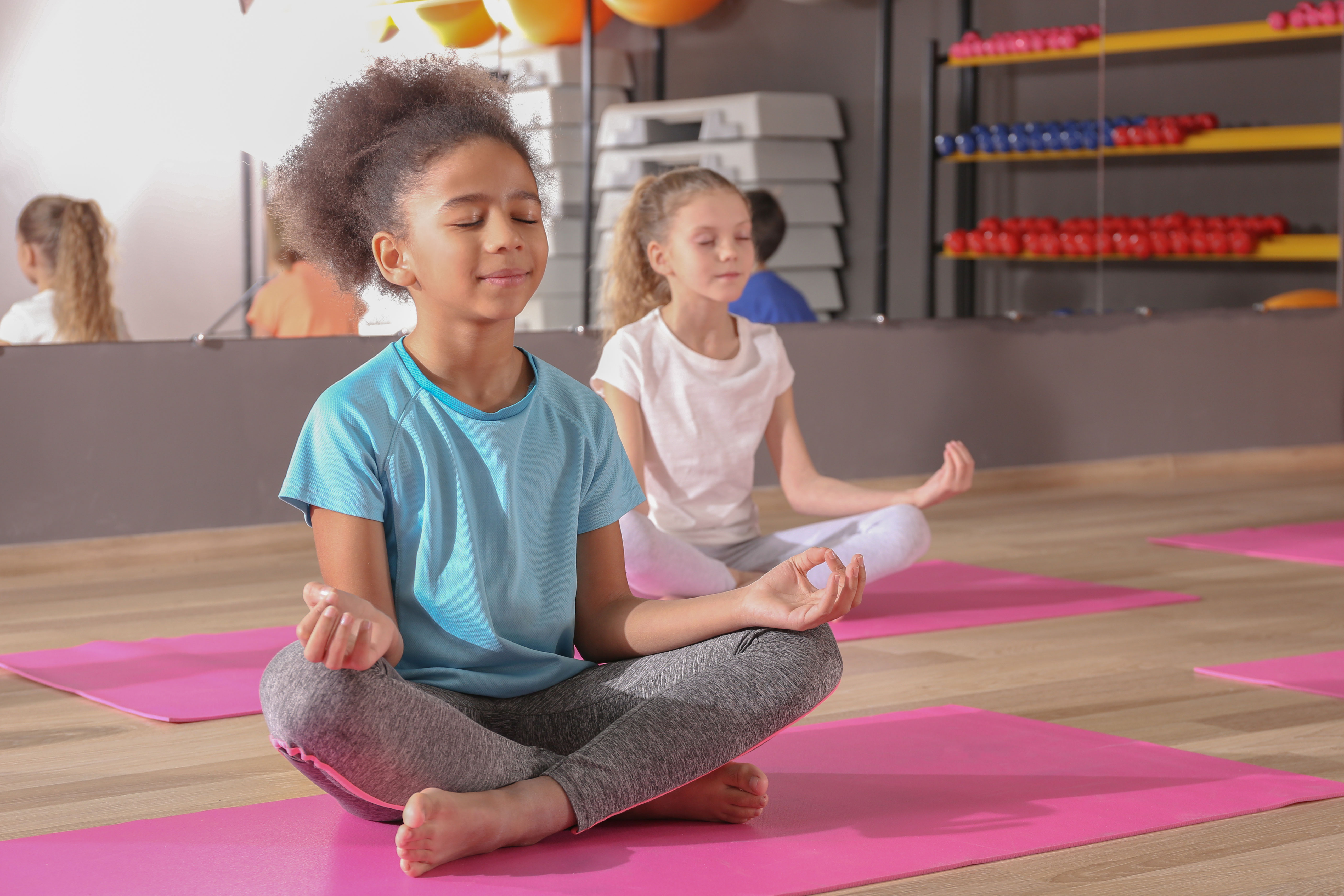 Young girl in blue top meditating 