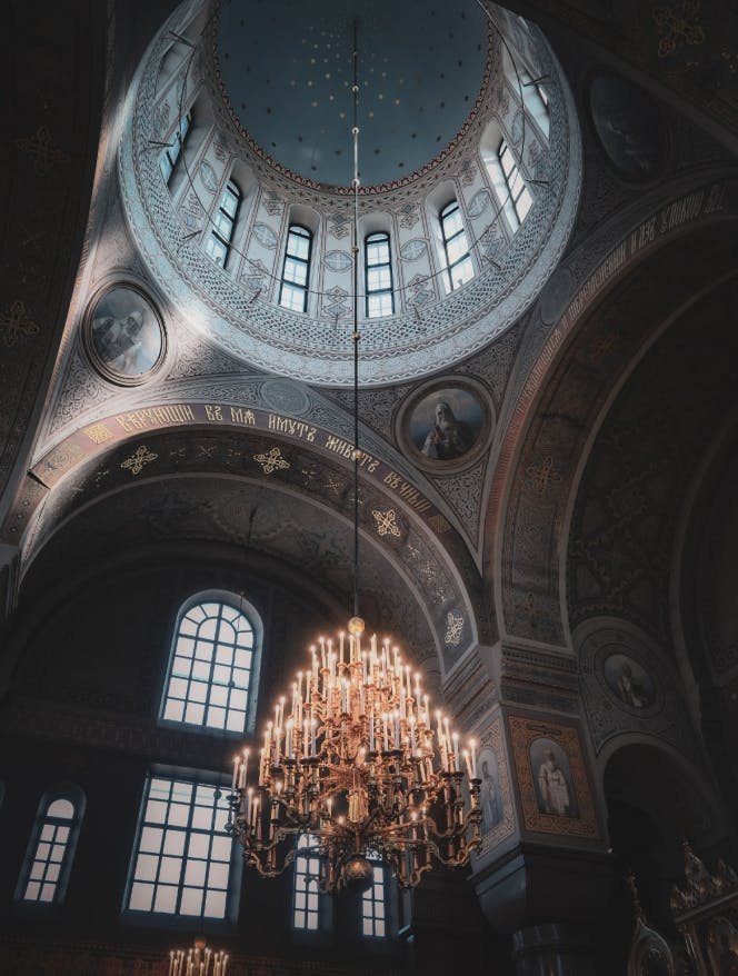 A chandeliers hanging from top dome.
