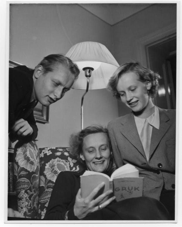 Lasse, Astrid och Karin tittar i en bok