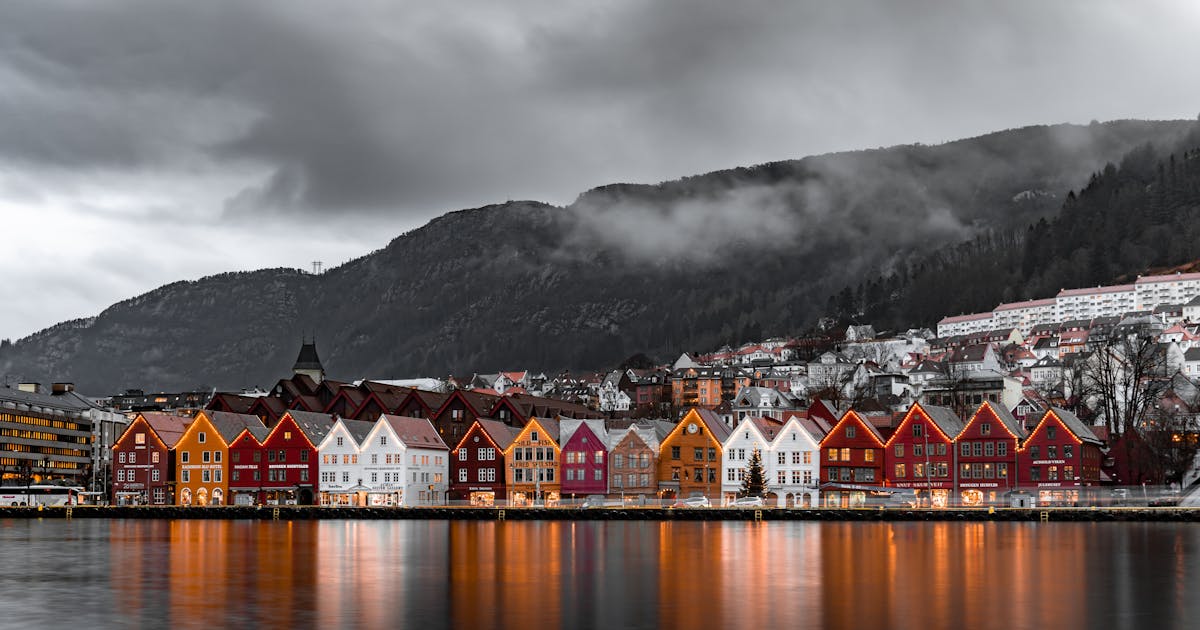 Beautiful colorful houses near a body of water on a grey cold cloudy day in Norway