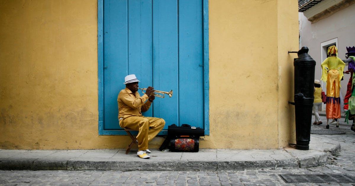 Man playing a trumpet on the streets of Havana, Cuba