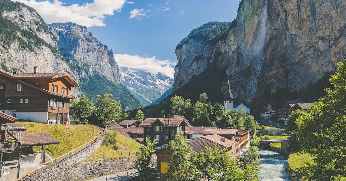 The beautiful town of Lauterbrunnen in Switzerland. Snow can be seen on the mountain tops.