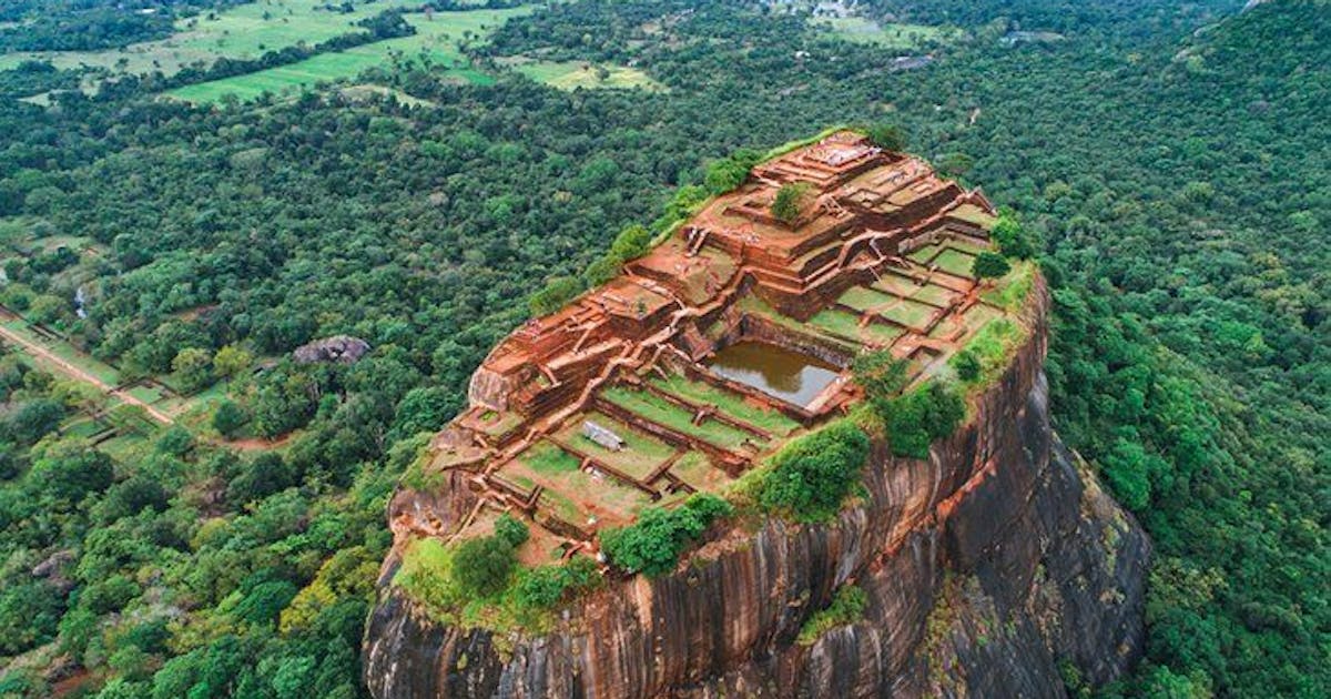 Beautiful aerial view of the Sigiriya rock fortress surrounded by trees during daytime
