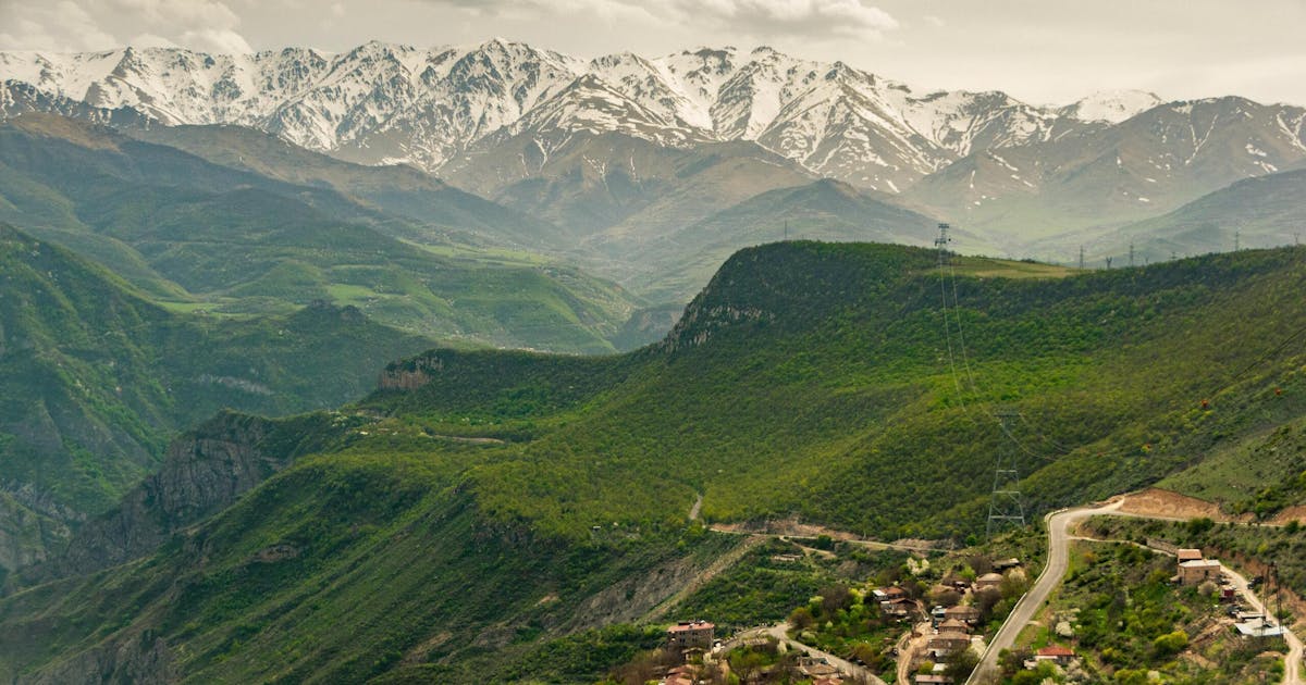 Beautiful green lush hills in Armenia. Snow can be seen on the mountain top in the background.