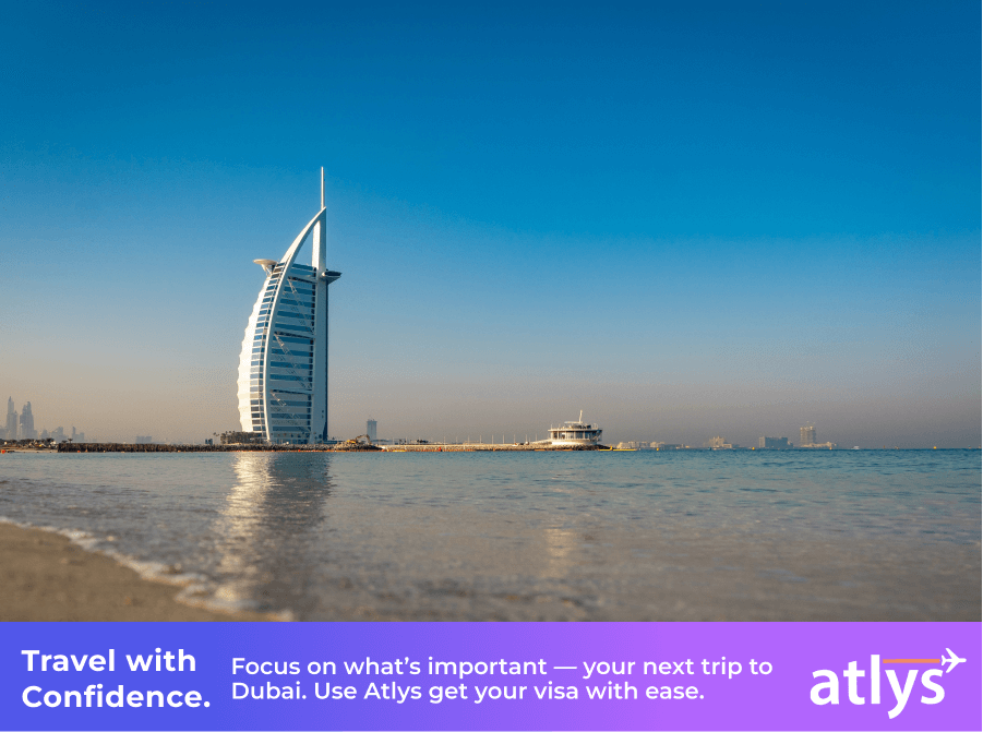 A water view with a skyscraper in the background and a blue sky.