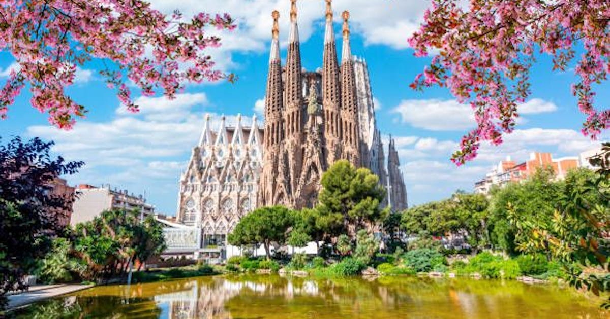 Beautiful old and magnificent cathedral in Spain. The cathedral is surrounded by lush greenery, flowers and a lake.
