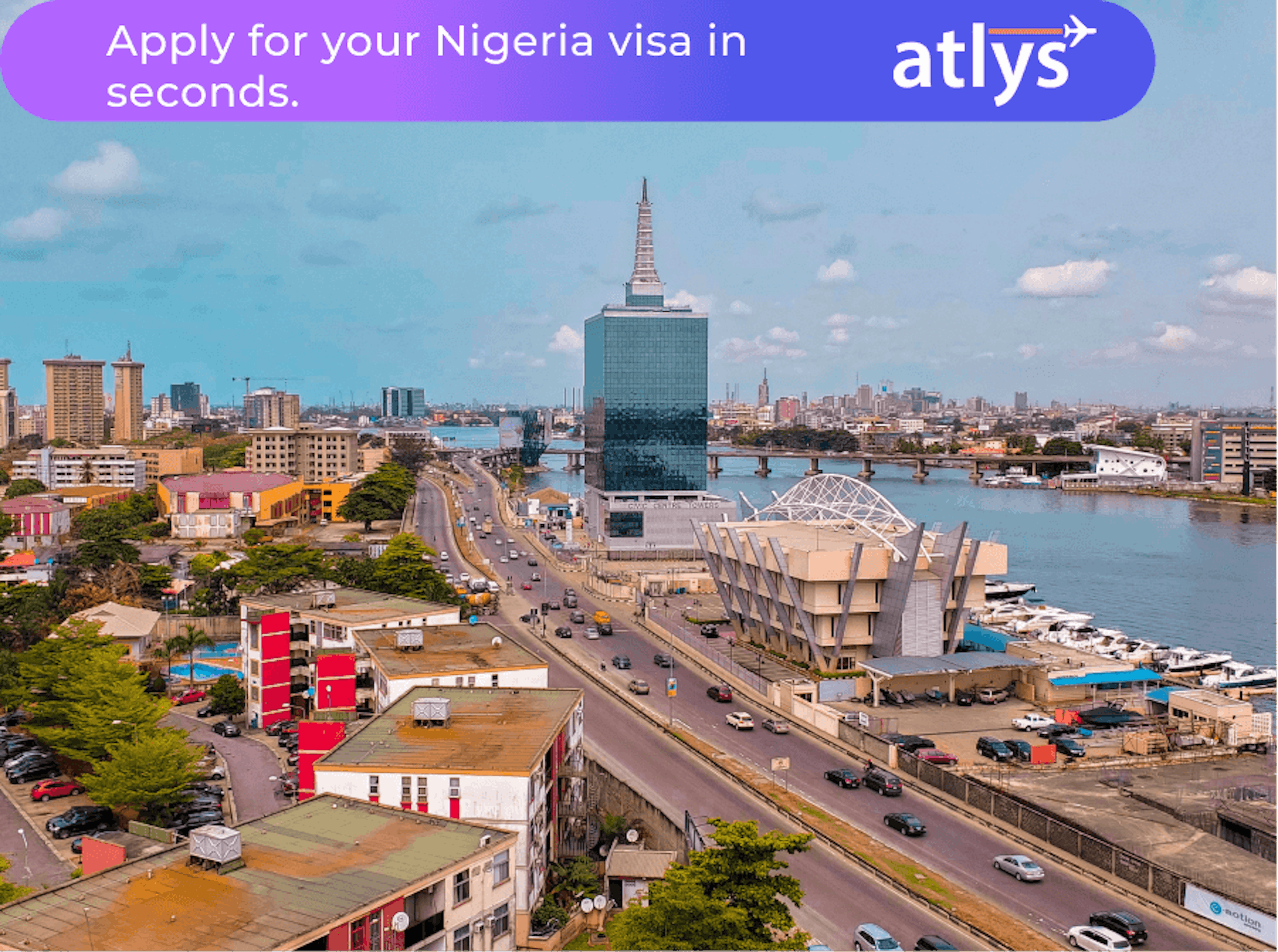 A bustling Nigerian city. A lot of cars can be seeing traveling on the road.