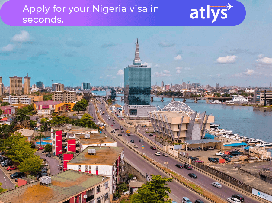 A bustling Nigerian city. A lot of cars can be seeing traveling on the road.