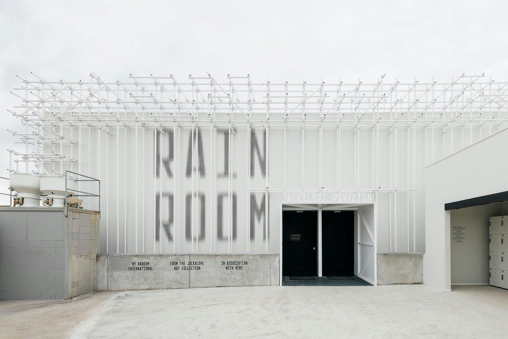 A white building with the name "Rain Room".