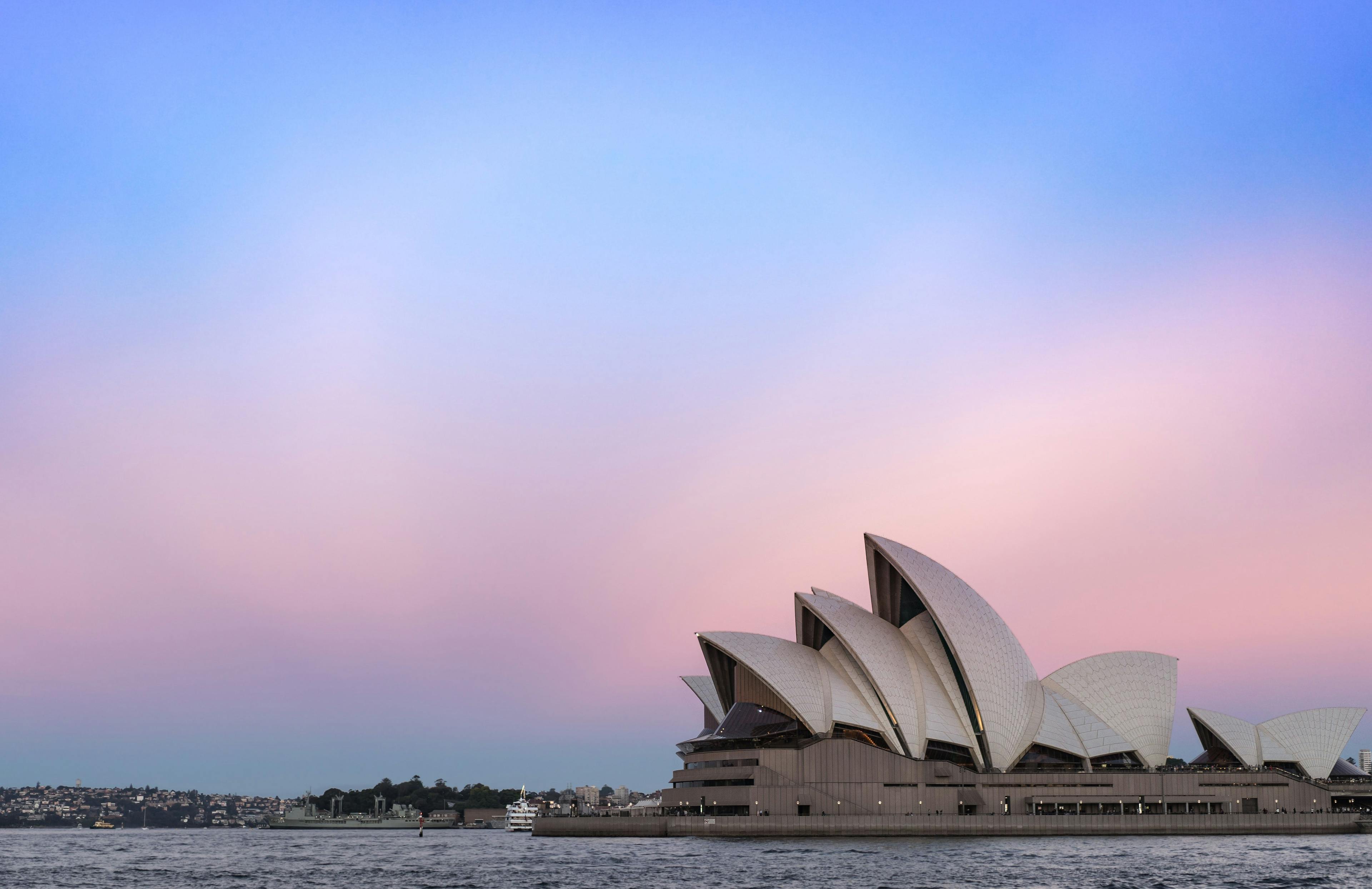 The opera house in Sydney Australia with a colourfull sky background.