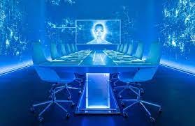 A room with blue lights containing a table with chairs and a monitor in the background.