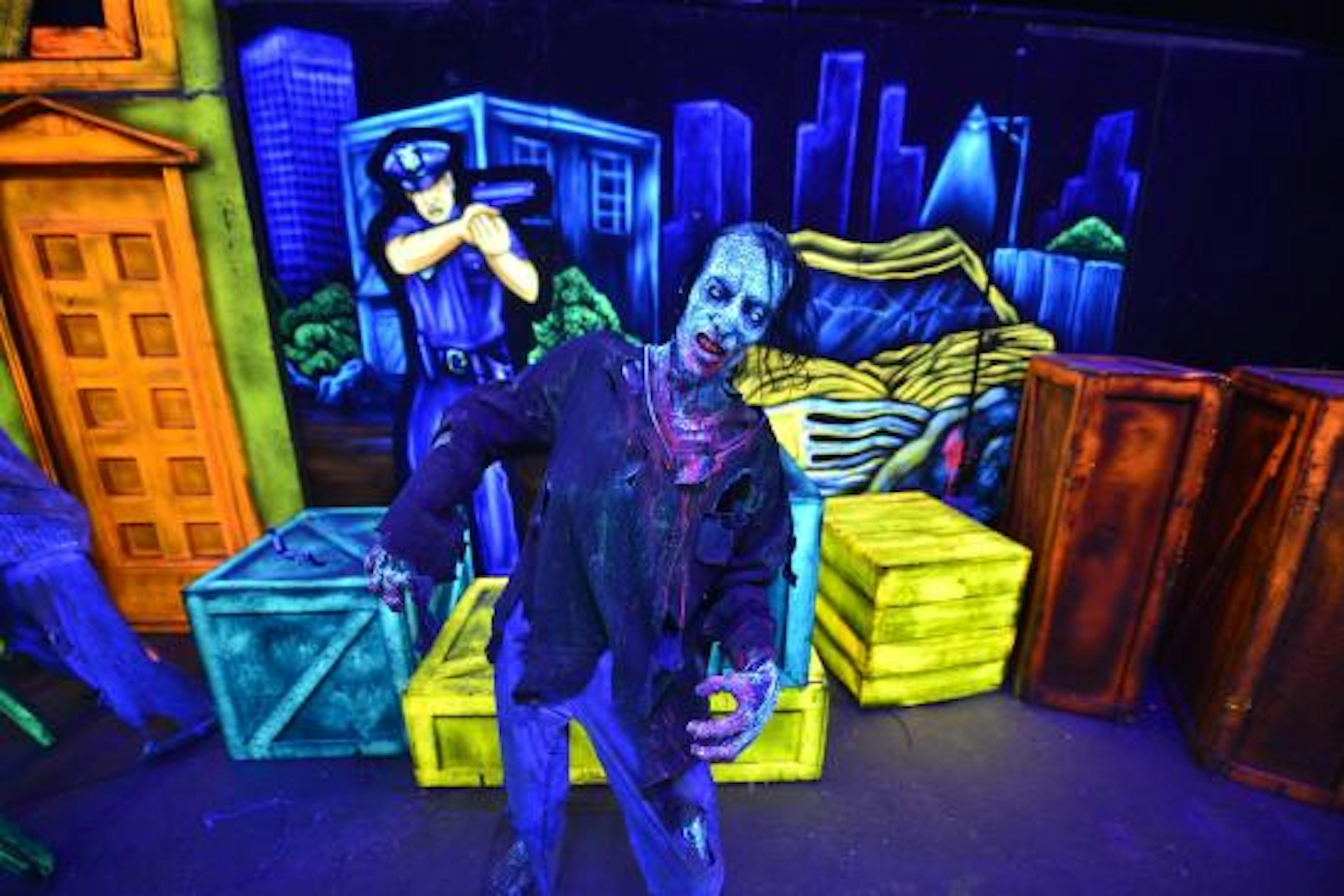 Blue, green, and brown boxes surrounding a modle zombie and police officer.
