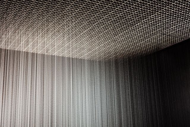 A room with water falling from the ceiling.