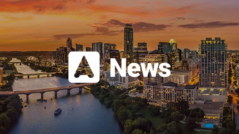 A city skyline with a sunset and the Atmosphere News logo.