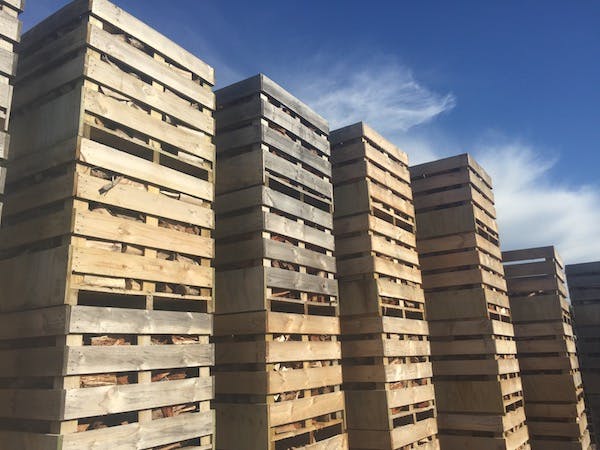 firewood is stored in large wooden crates