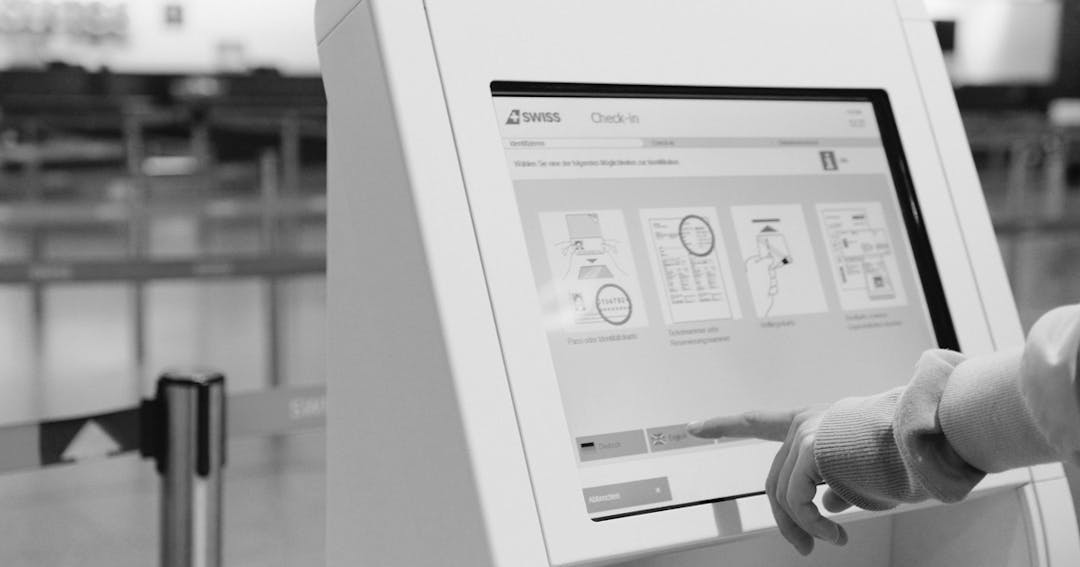 Photo of a kiosk being used to check-in for a flight at an airport