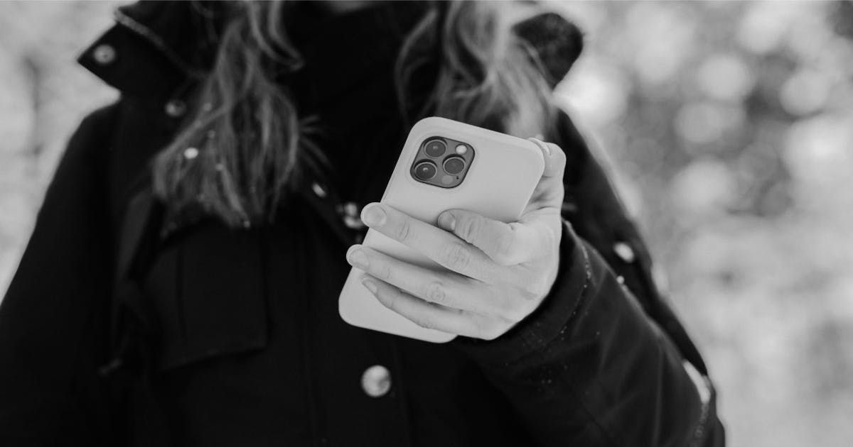Woman looking at a phone in her hand