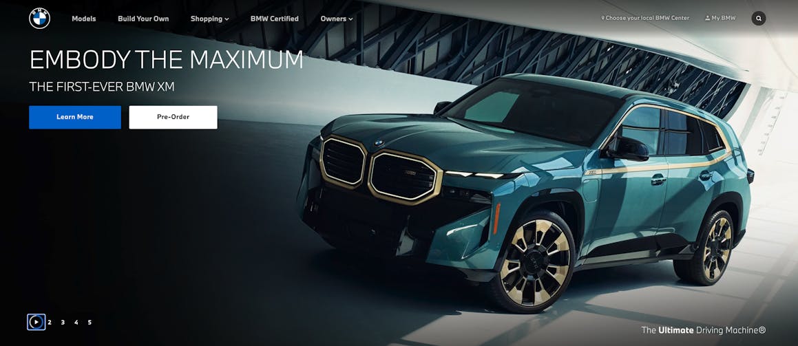 A blue BMW SUV that is part of a home page carousel. The play-pause functionality button is currently paused.