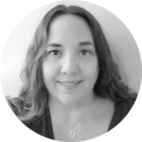 A black and white photo of Alisa Smith, she is a white woman with long wavy hair wearing a black shirt.