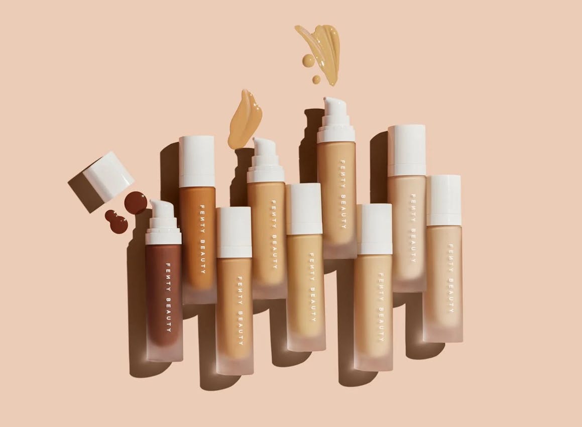 A line of nine makeup tubes, starting with a dark brown shade on the left and getting progressively lighter until the final tube, which is a light beige. Credit to Fenty.