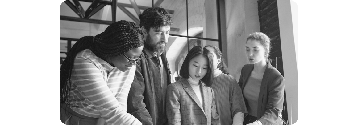 Five diverse colleagues working on a project together