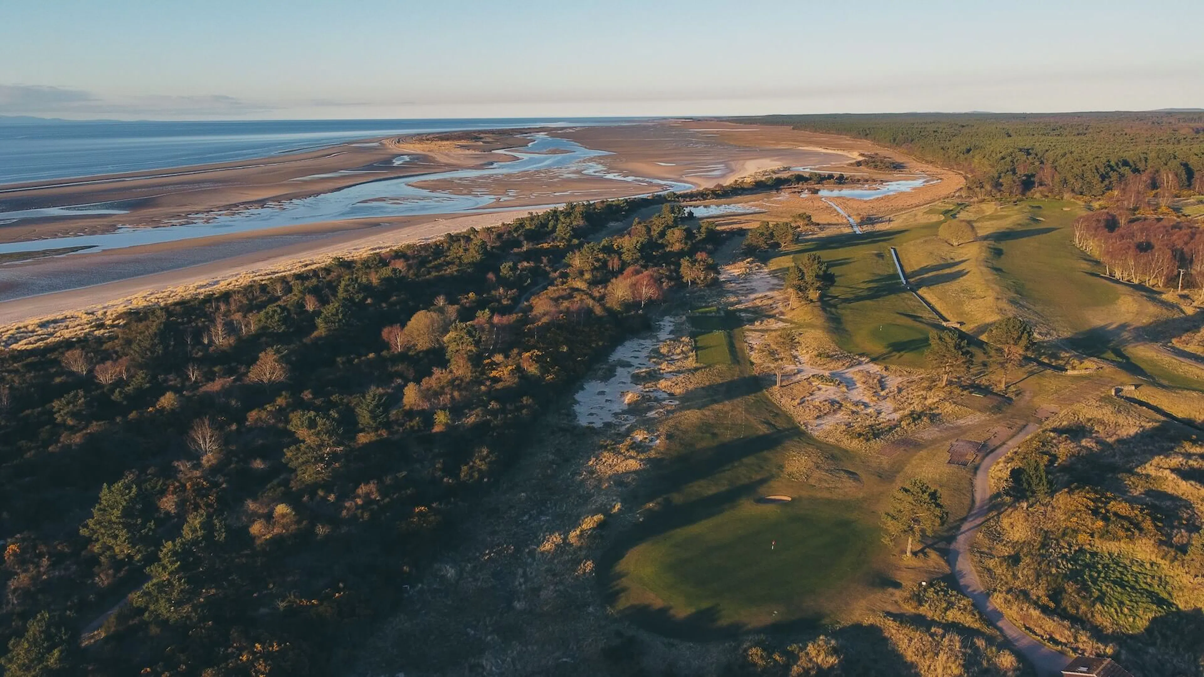 Aerial view of Nairn Dunbar Golf Club and Moray Firth in the background. 
