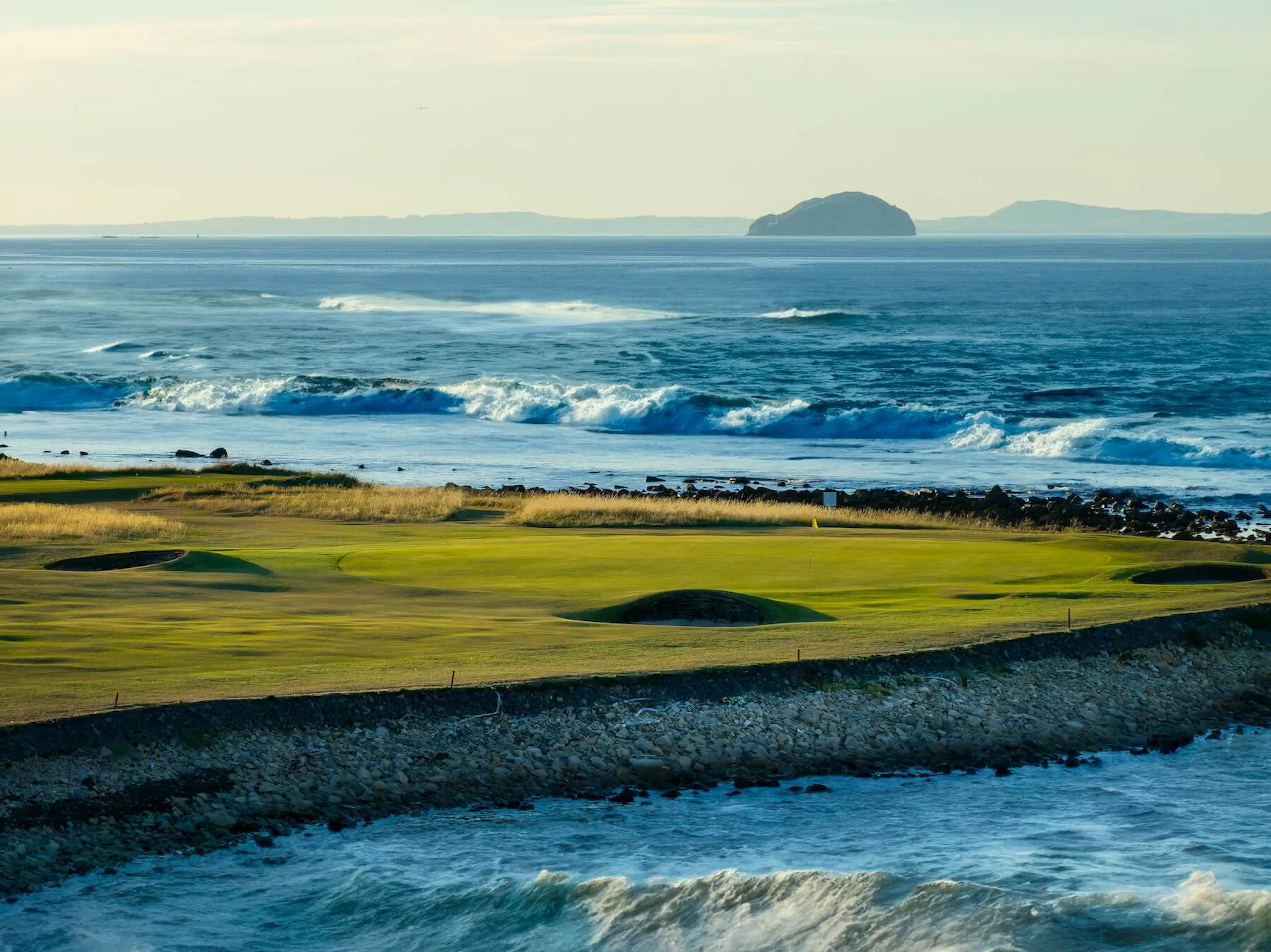 Beautiful view of the waves crashing against the coast at Dunbar Golf Club