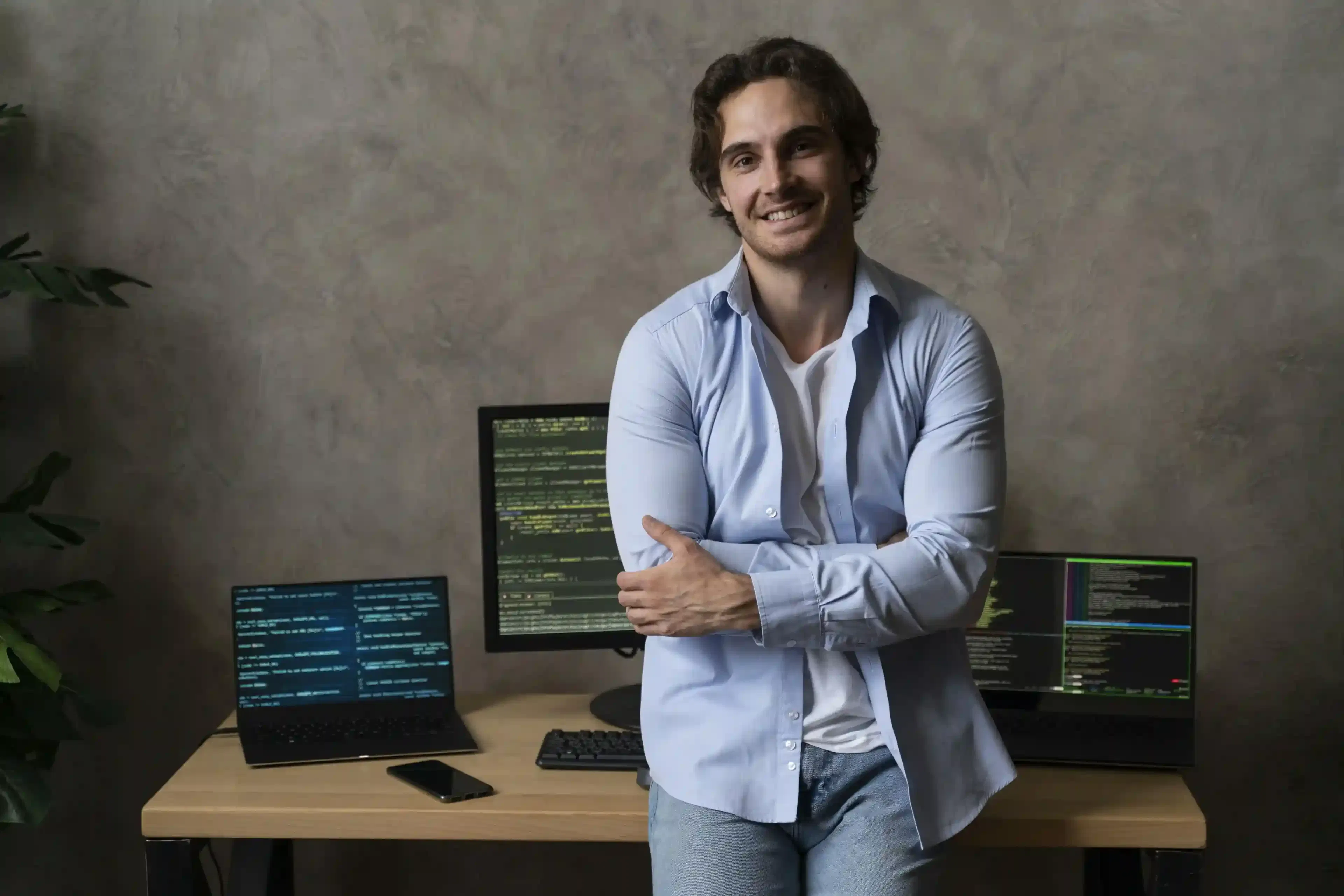 smiling programmer working at computer in office