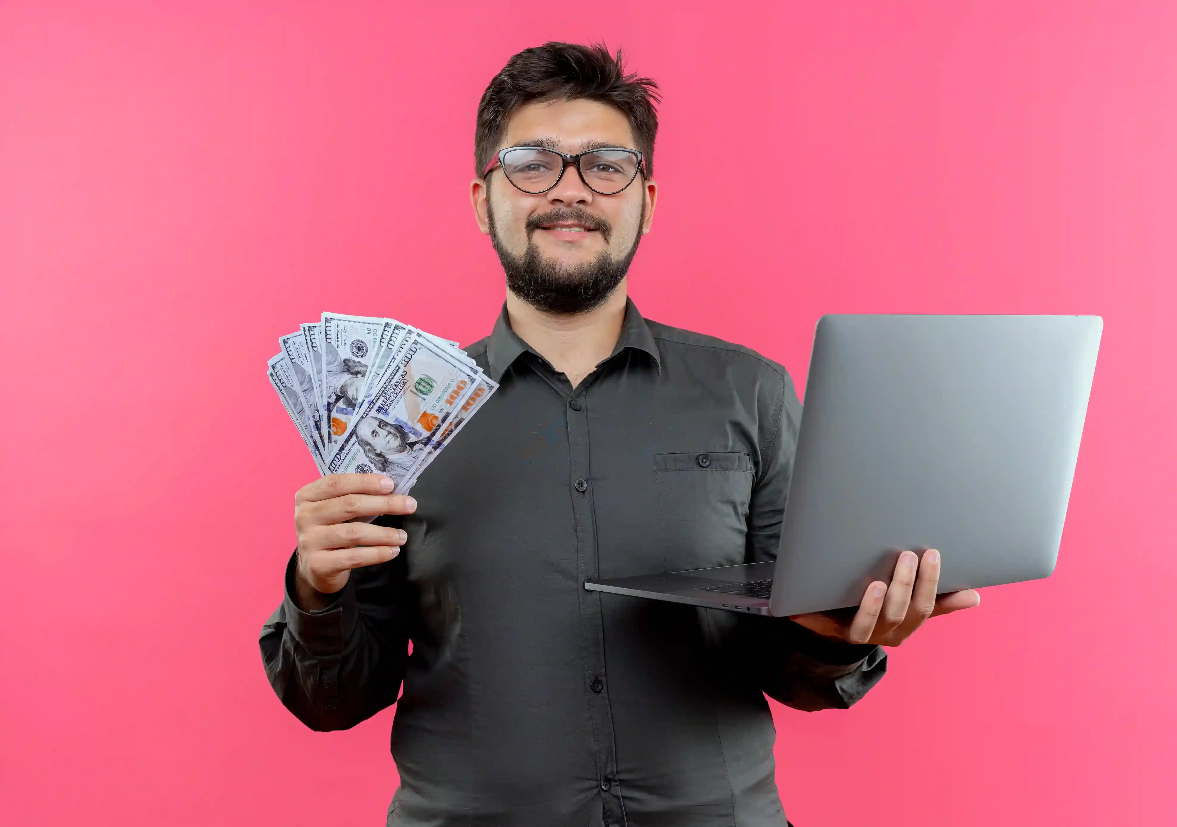 young businessman holding laptop checking software salary info