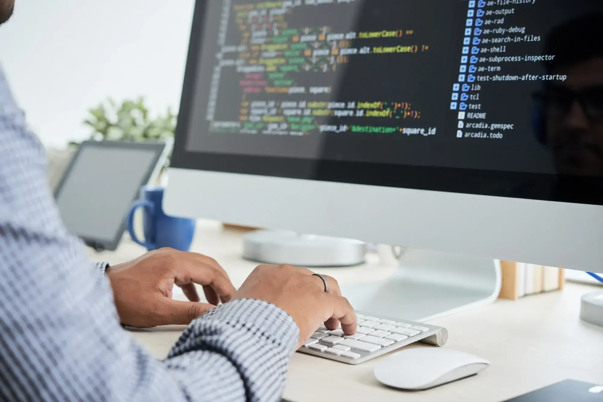 software developer coding on desktop workstation
