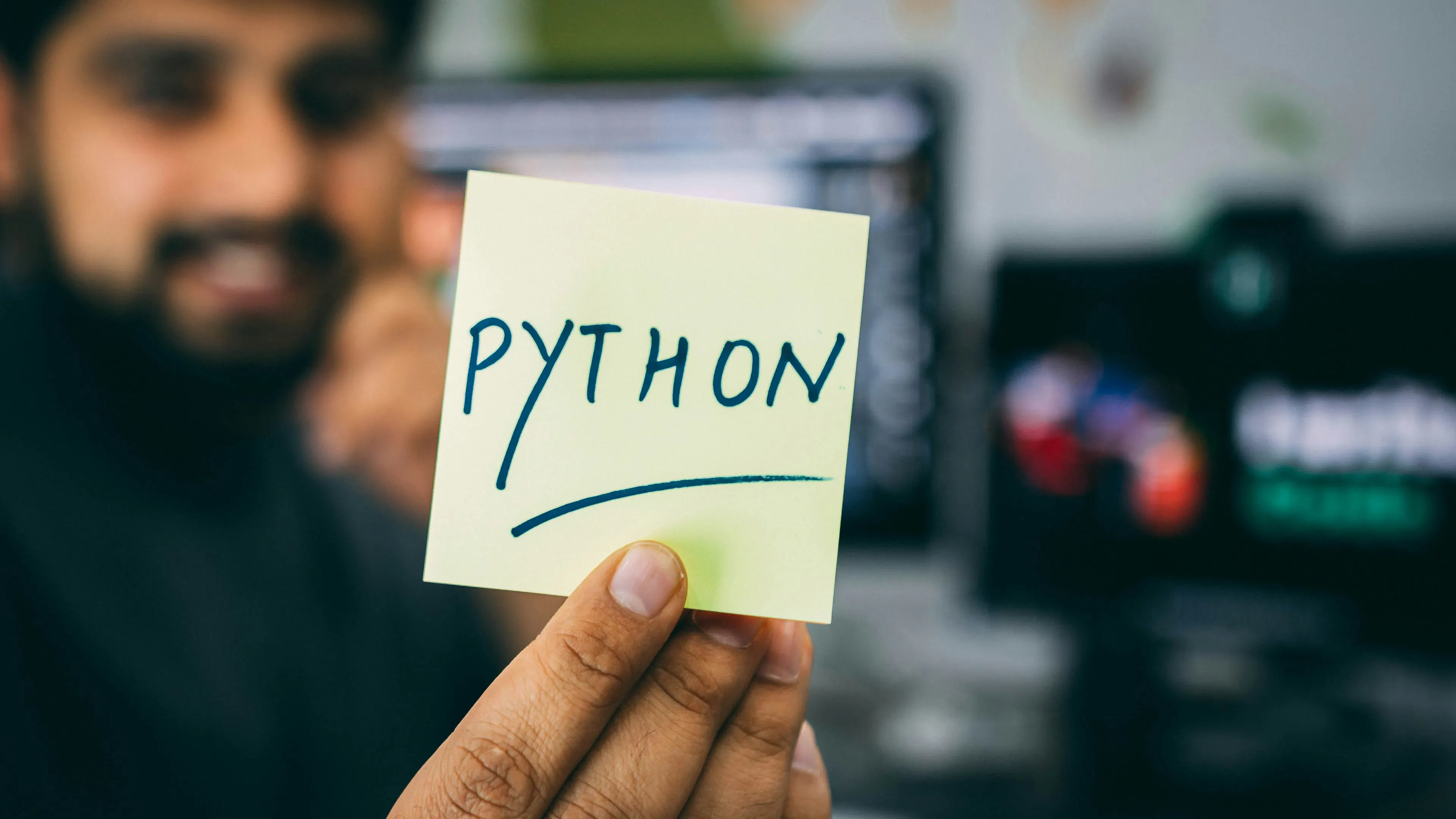 Python programming professional working on software project in modern office