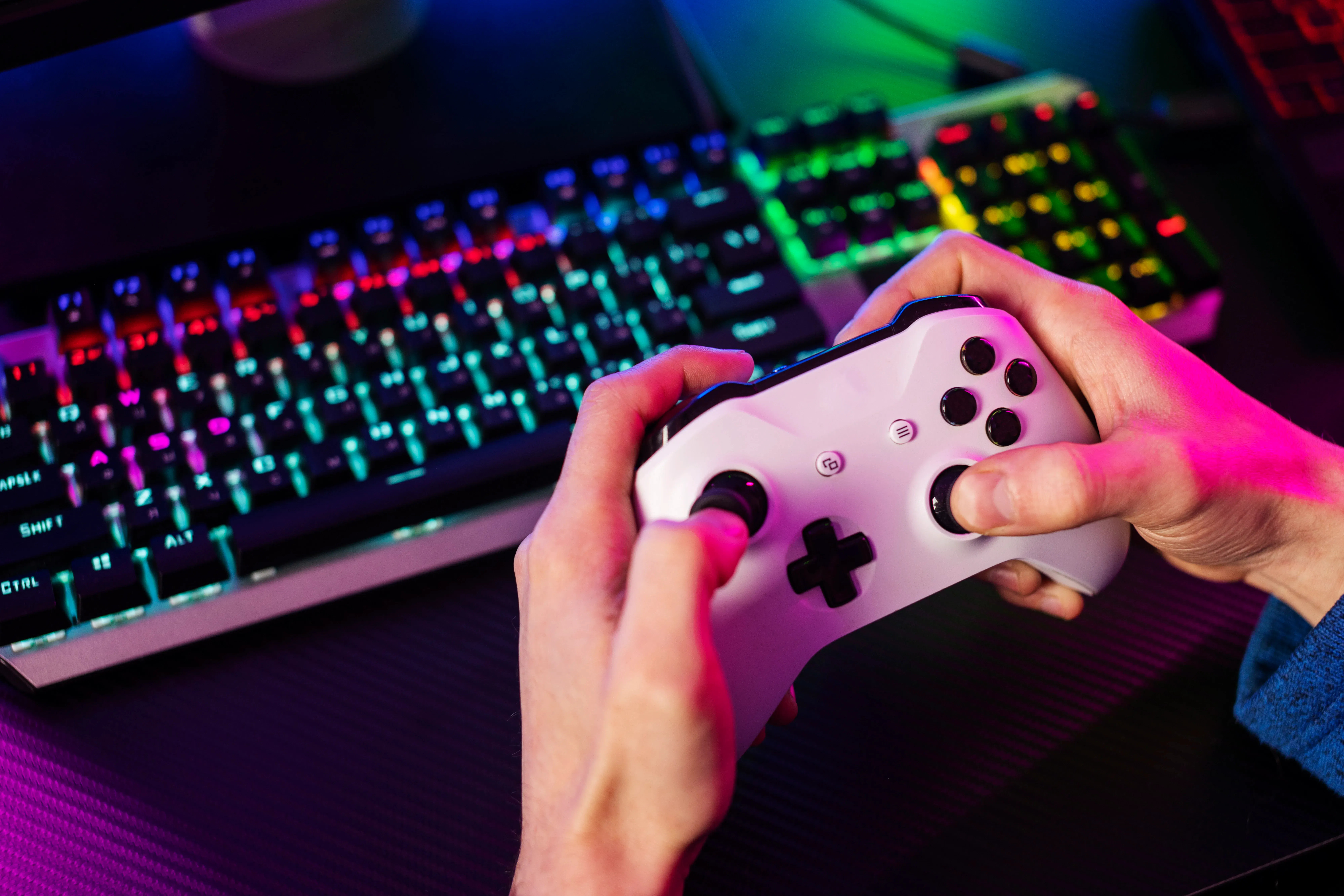 high-angle view of hands holding game controller