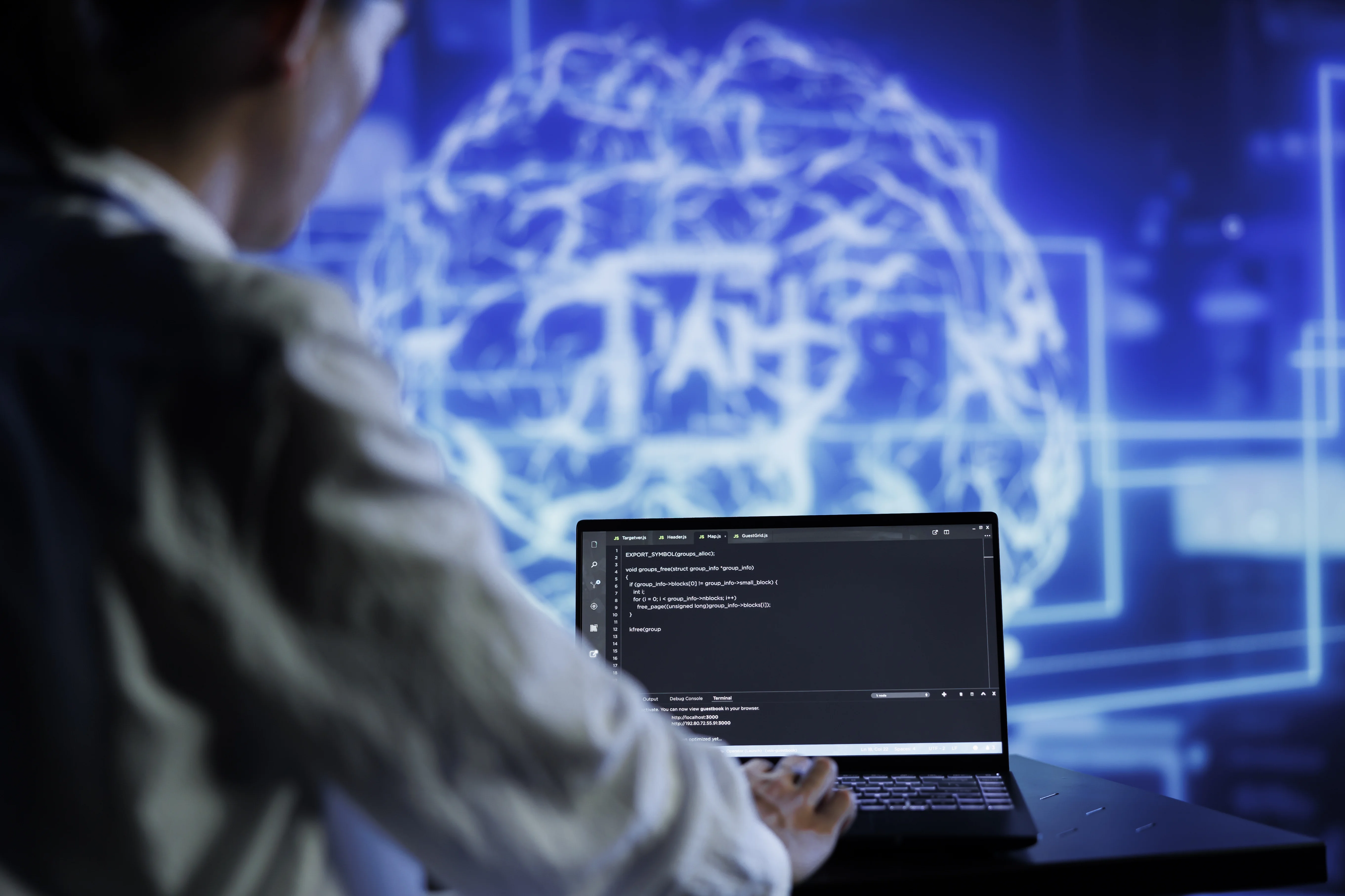 developer working with AI programming languages on laptop