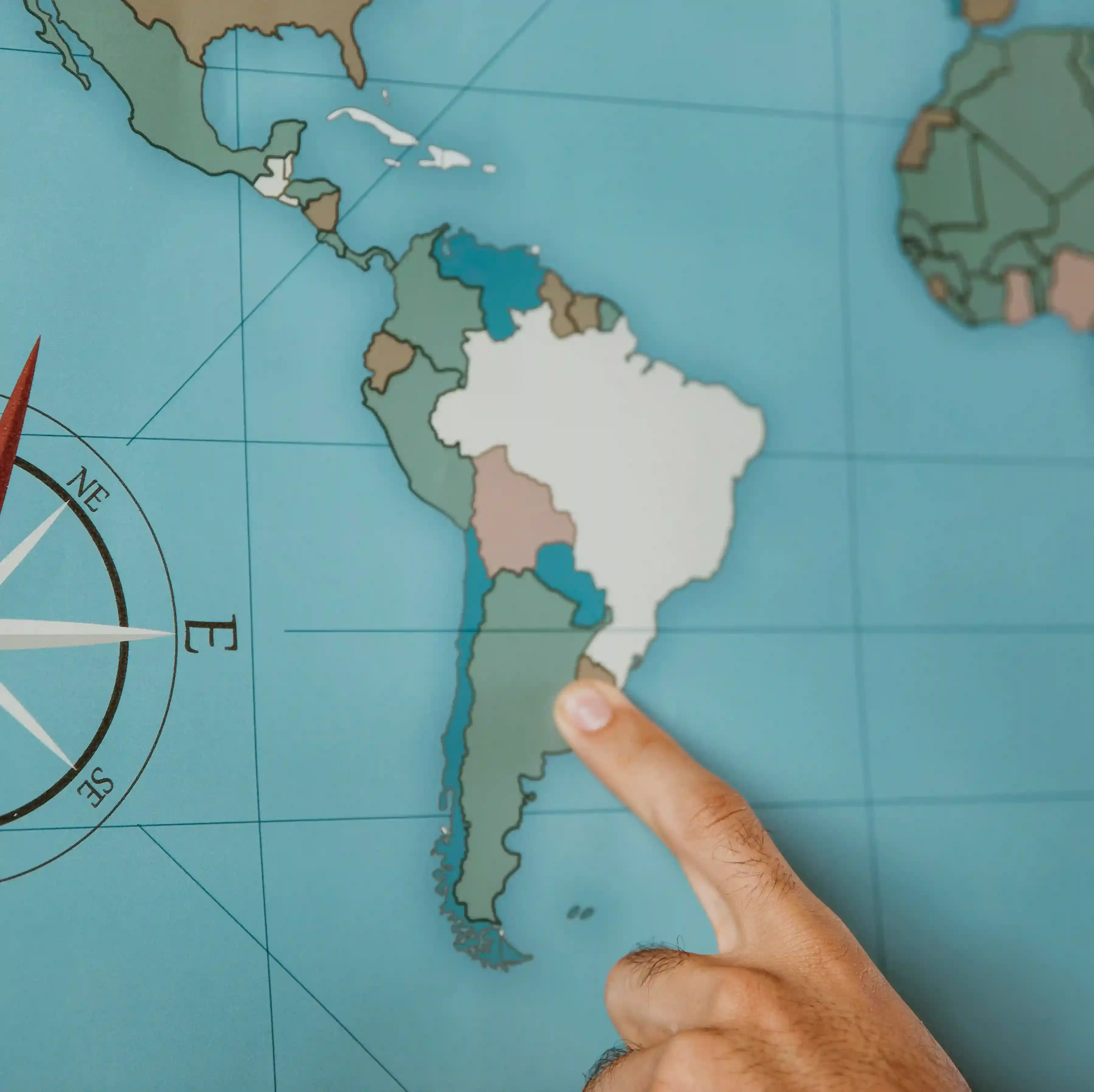 person pointing to South America on map for nearshore work