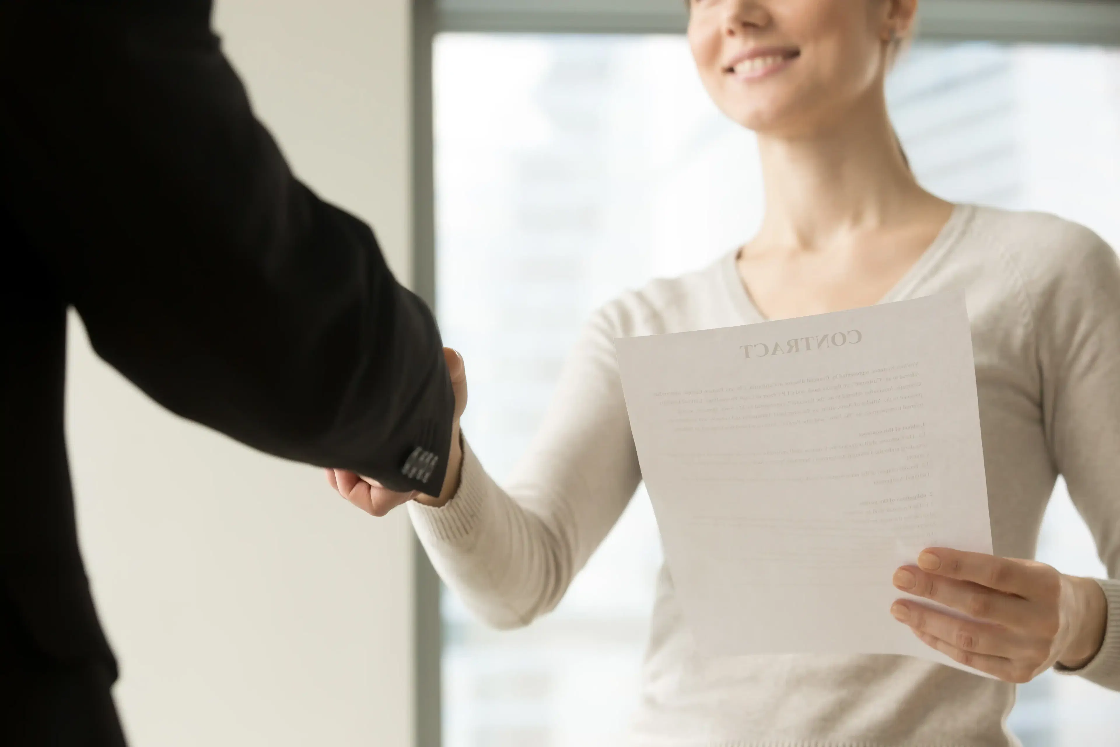 female CEO congratulating partner after successful deal