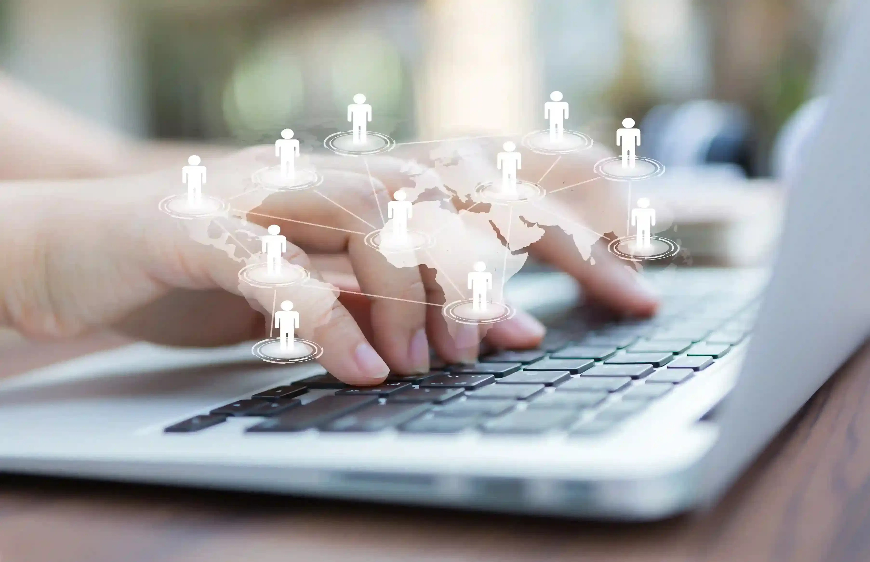 hands on laptop with virtual world map for remote work