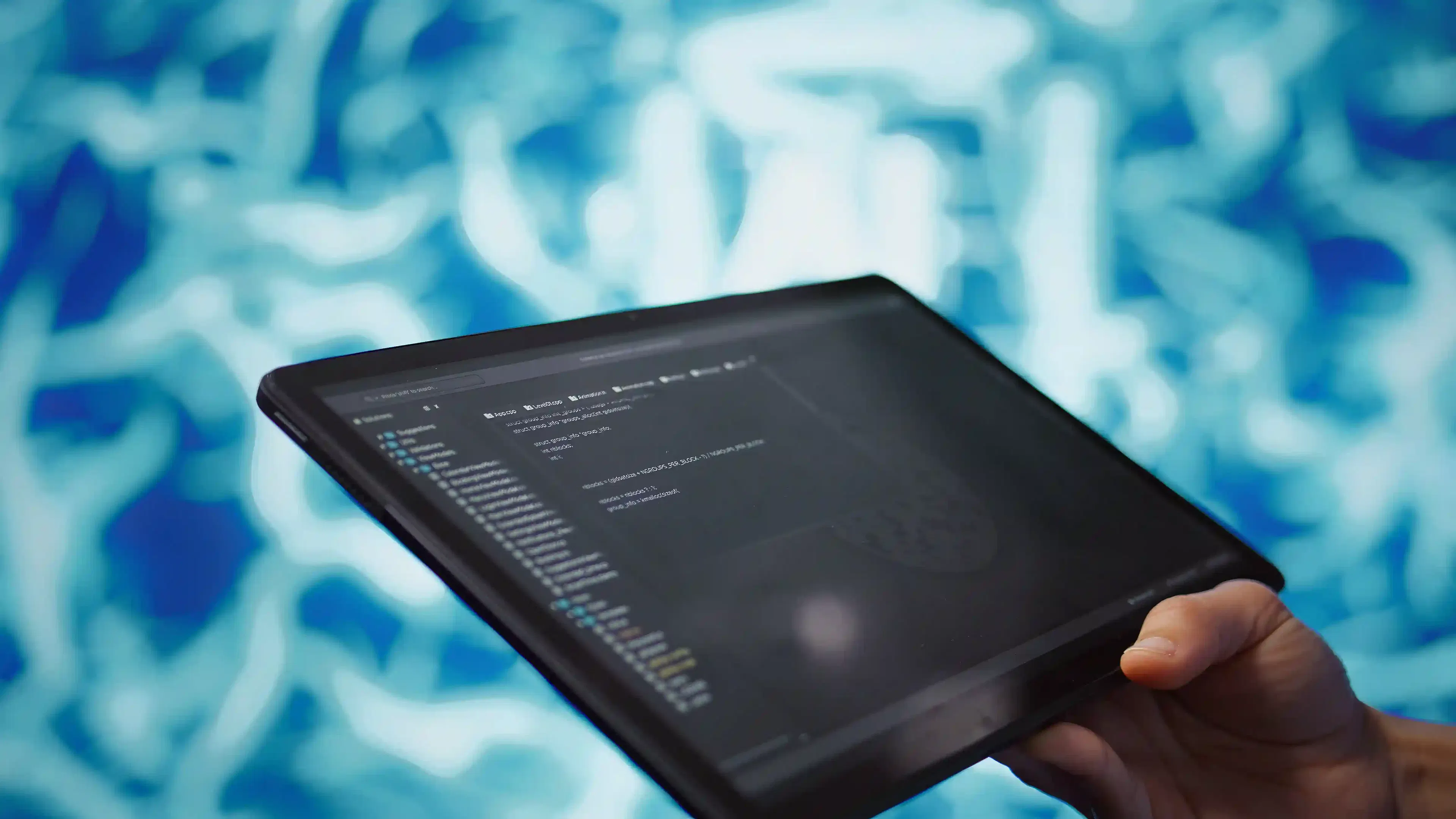 close-up of IT professional using AI algorithms on tablet