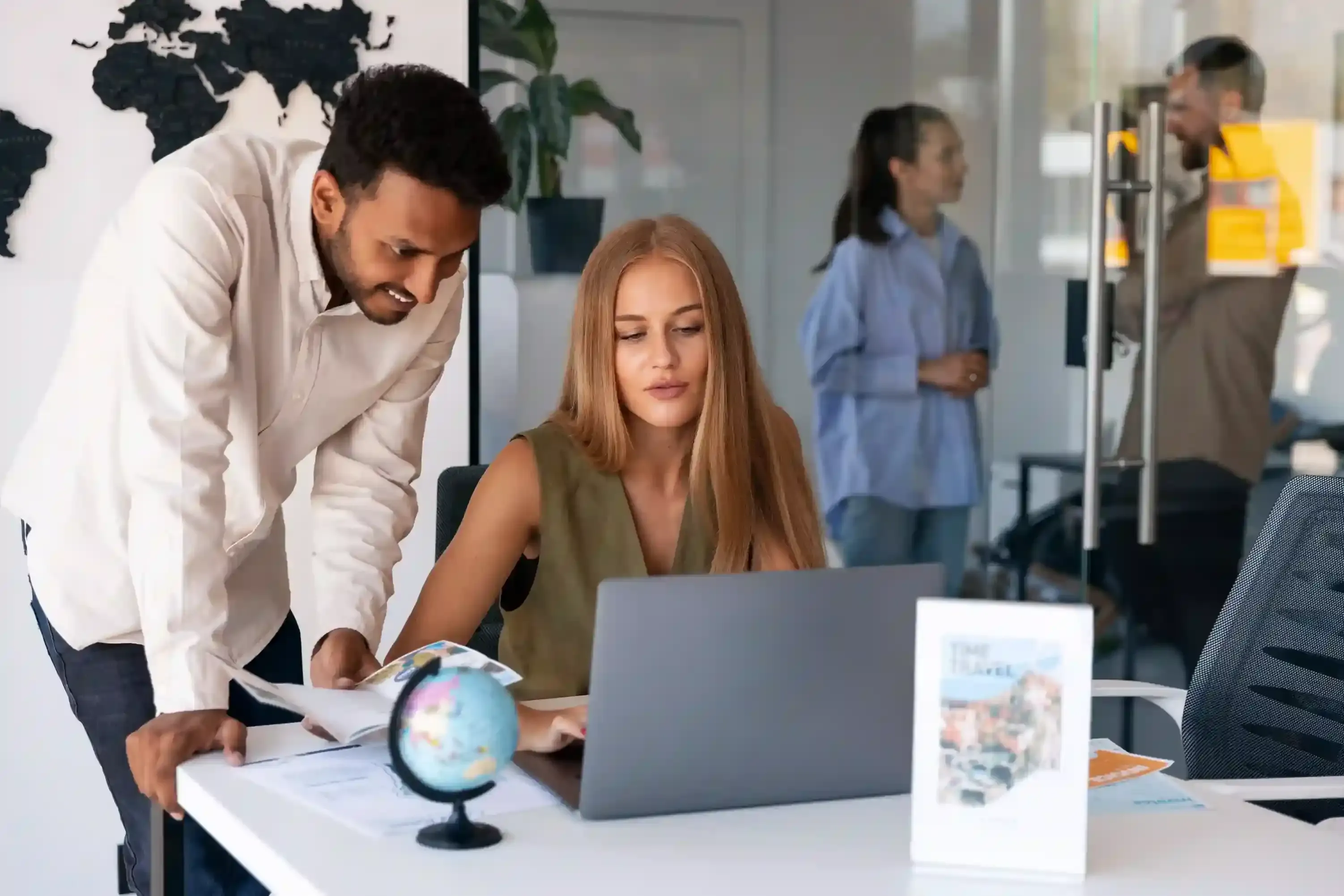 professionals working at desks in a tech company office