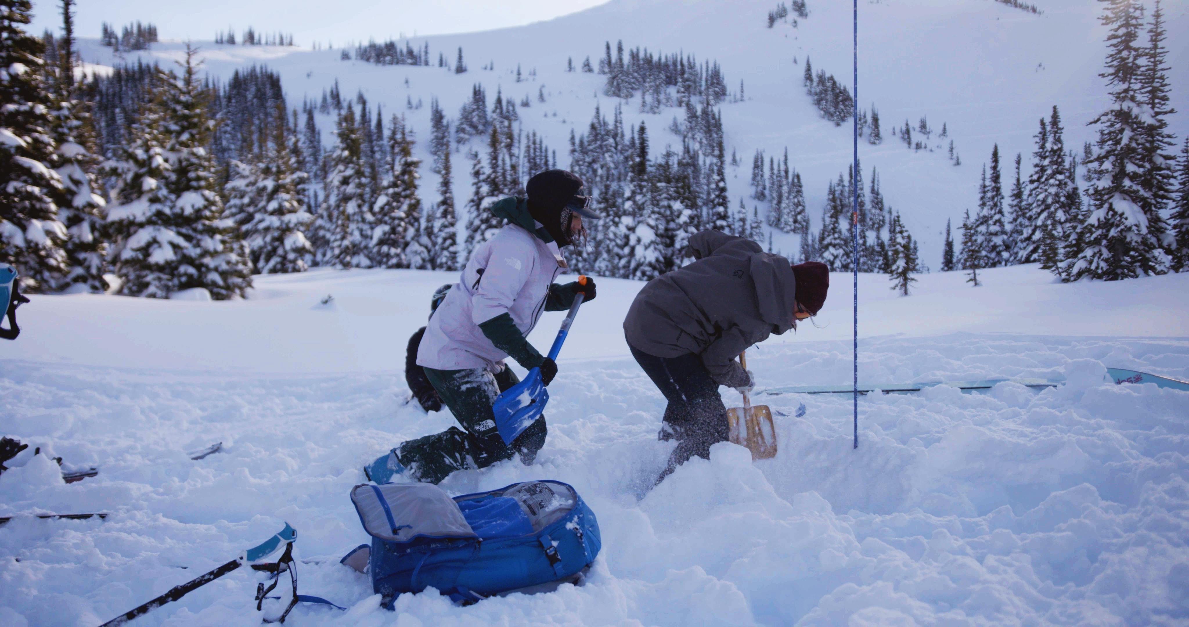 Two women dig next to a probe in a companion rescue training scenario. 