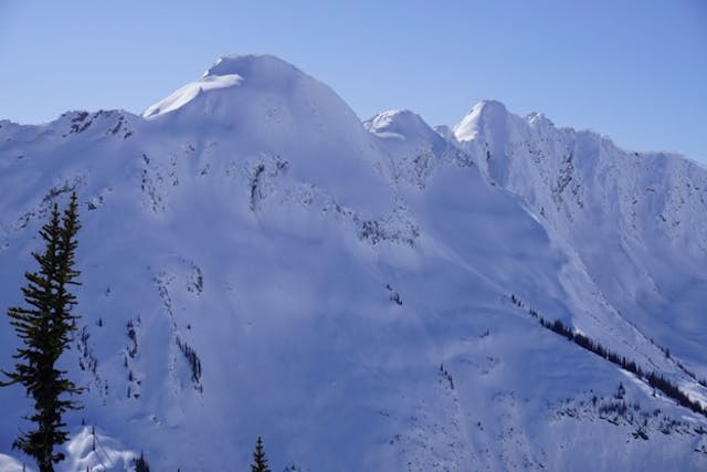 Image shows large, open alpine slope with no tracks on it