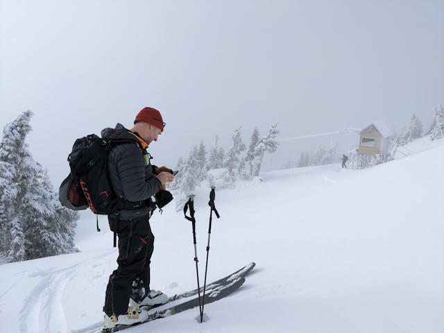 Forecasting supervisor, James Floyer, checks his phone in the field.