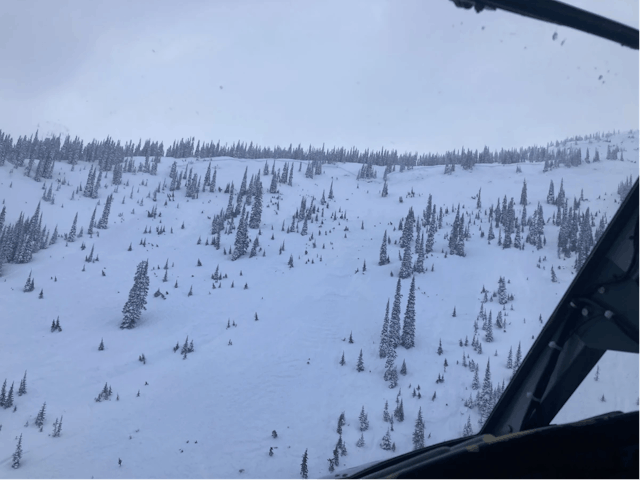 Image taken from a helicopter showing a widely-propagating avalanche.