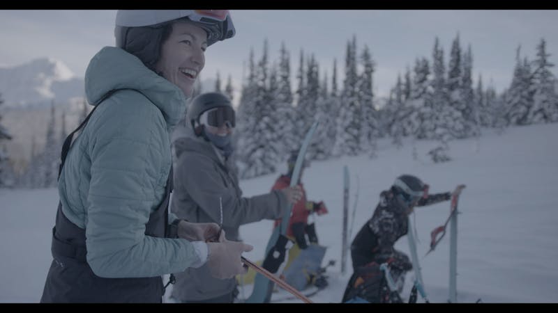 Female backcountry skiers prepare for a descent