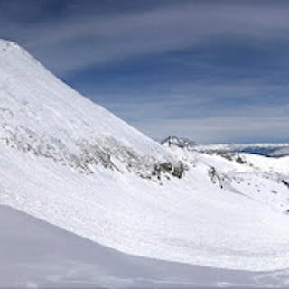 A very large avalanche on an alpine feature.